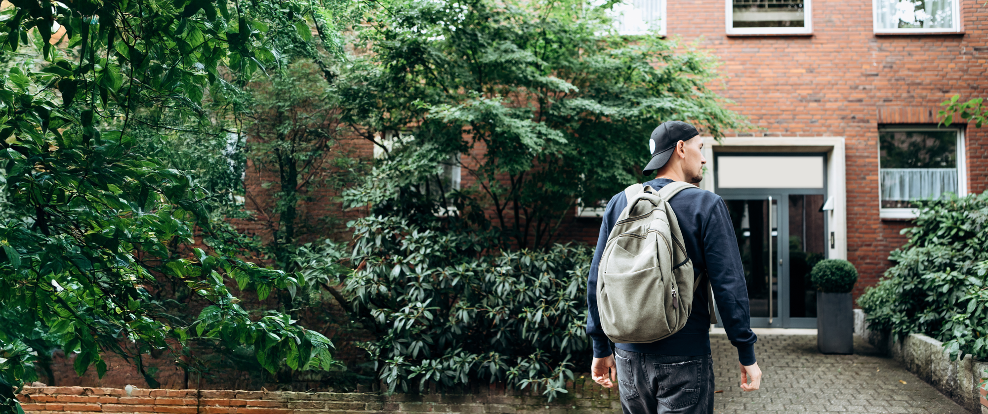 man with back pack building